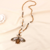 Sautoir perles cristal facettées et pendentif maxi abeille métal doré 0123141 marron